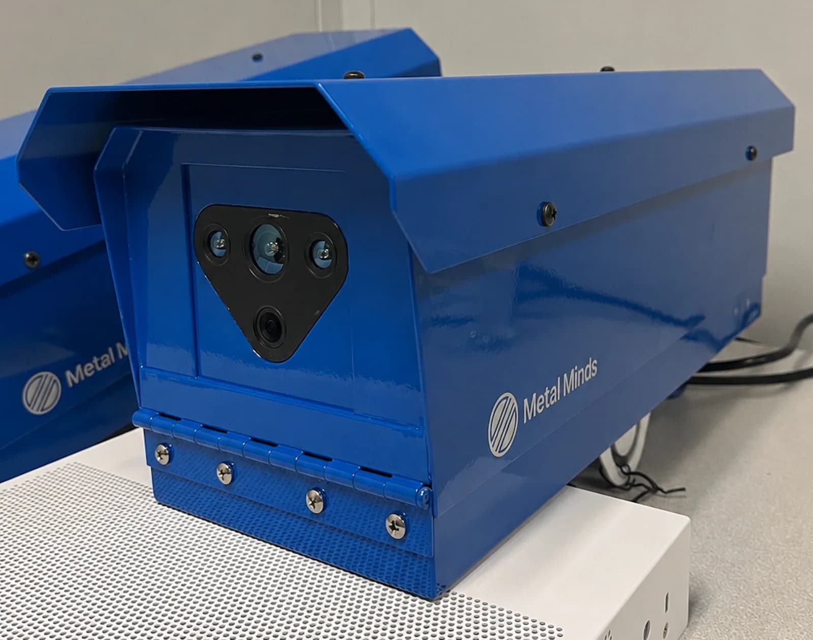 MMI LaserVision-001 in its blue aluminium enclosure, showing the sensor plate and the integrated sun hood
